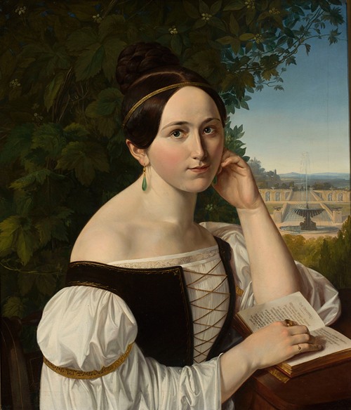 Portrait of a young woman with a book in a park