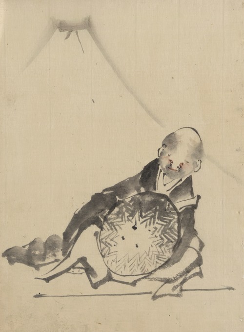 A monk reclining, holding a large conical hat in front of him, with view of Mount Fuji in the background