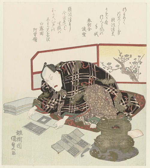Man folds miniature kimonos