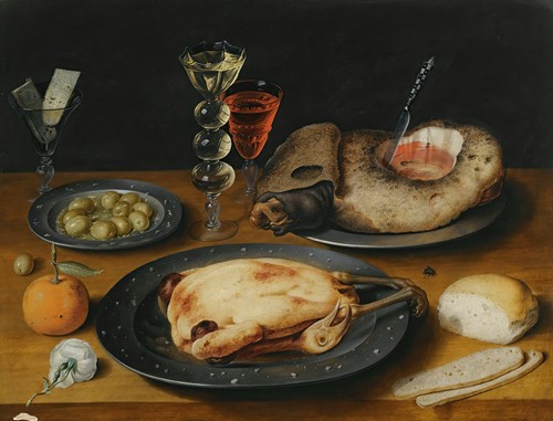 A Still Life Of A Roast Chicken, A Ham And Olives On Pewter Plates With A Bread Roll, An Orange, Wineglasses And A Rose On A Wooden Table