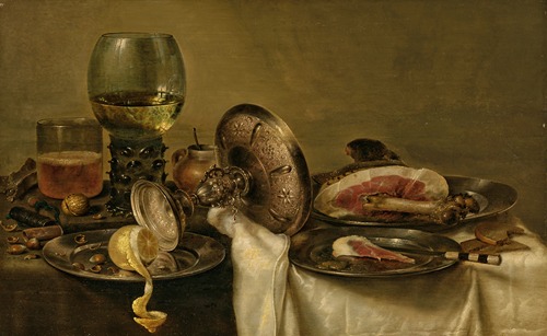 A partially draped table with an overturned tazza, roemer and glass of beer, with a partially peeled lemon and ham on pewter plates