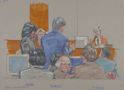 Oprah Winfrey standing as her attorney, Charles Babcock, questions plaintiff Bill O’Brien on the witness stand while the judge and others in the courtroom look on