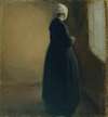 An old woman standing by a window