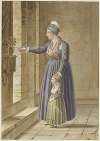 Junge Frau mit ihrer Tochter in provençalischer Tracht an einem Kirchenfenster