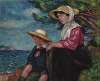 Femme et jeune garçon assis au bord de la mer