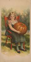 Girl in red chair with pumpkin