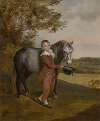 A young boy, holding a pony and hat, in a landscape