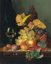 A roemer, grapes, peaches, plums, raspberries and walnuts on a wooden ledge