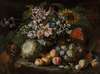 A still life of fruit and flowers in a footed gadrooned silver vase with a spaniel looking on