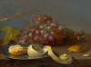 Still life with grapes, a lemon and bread on a table