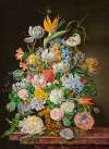 A bird of paradise, roses, tulips and other flowers in a gilt bronze vase on a stone ledge